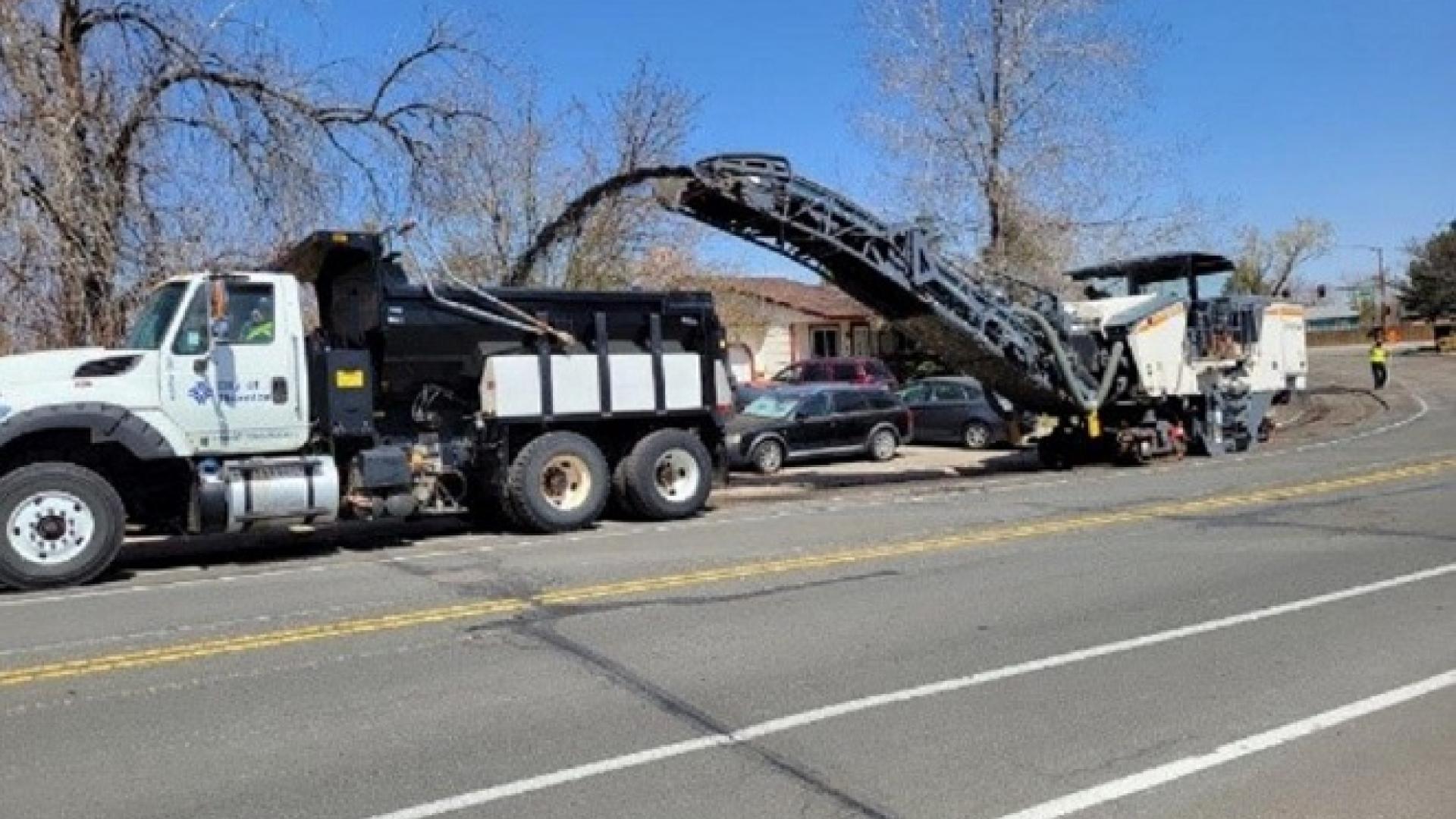 Mill and pave machine discharging into dump truck