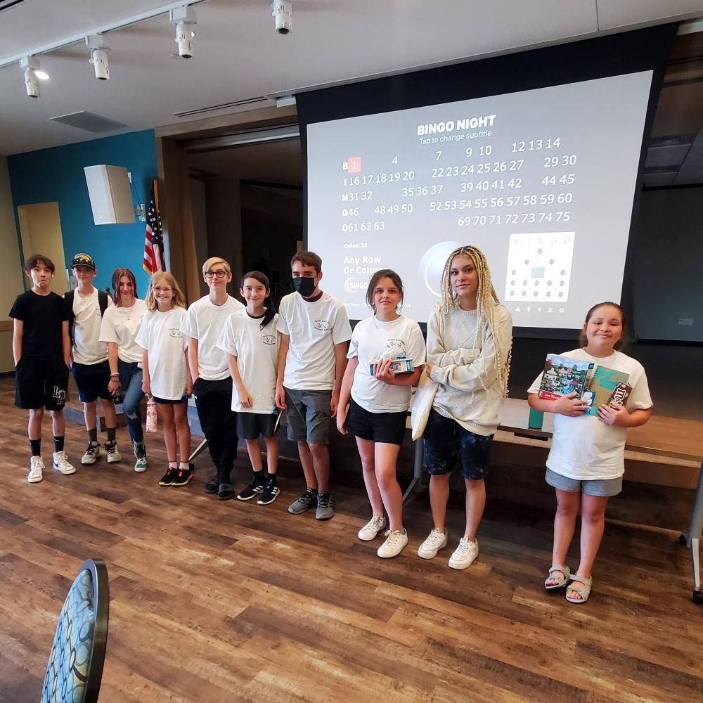Group of youth standing in front of a projector