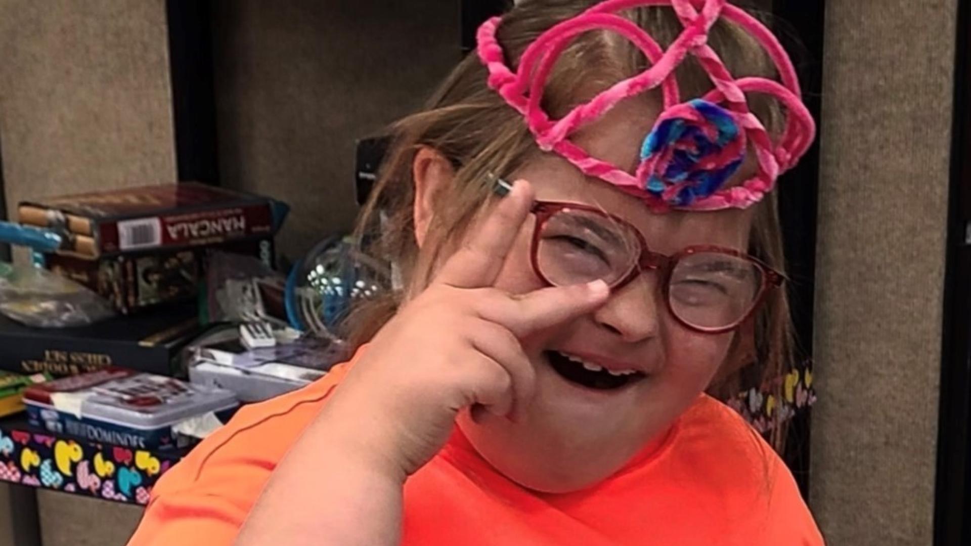 Young girl at Thornton Summer Camp holding up the peace sign