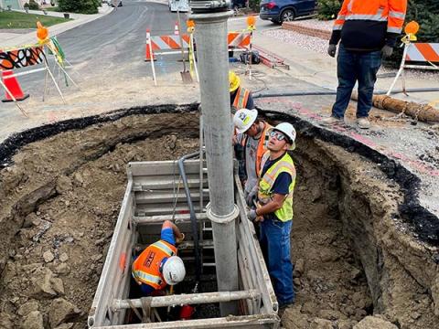 Five employees working on a water break repair.